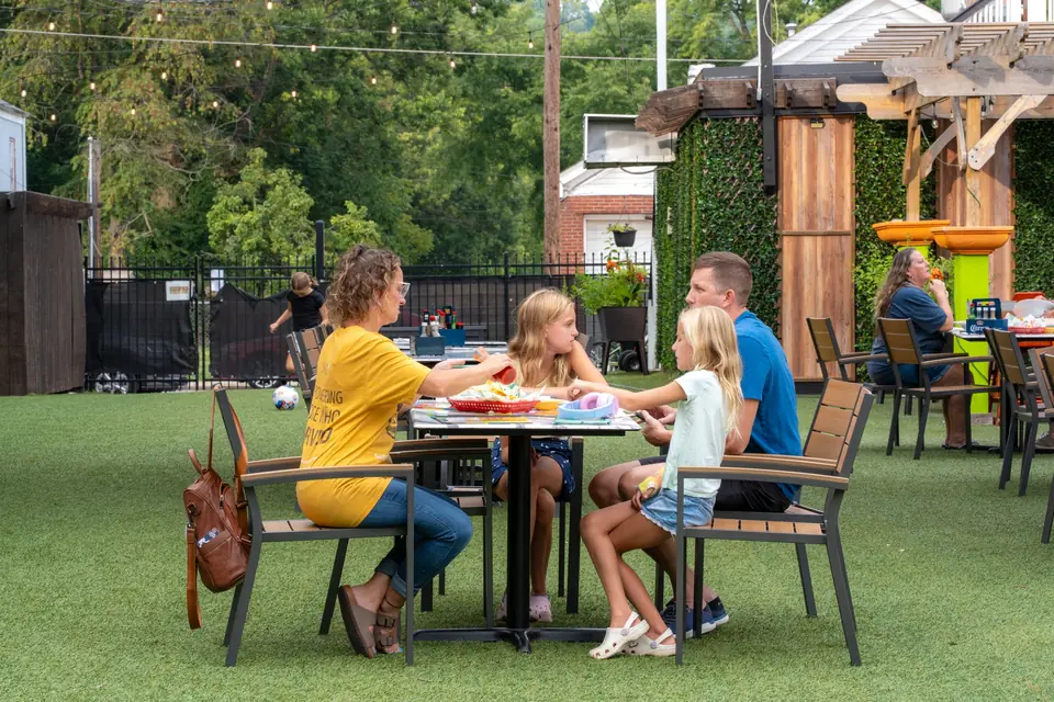 A family at a lawn table on the terrace