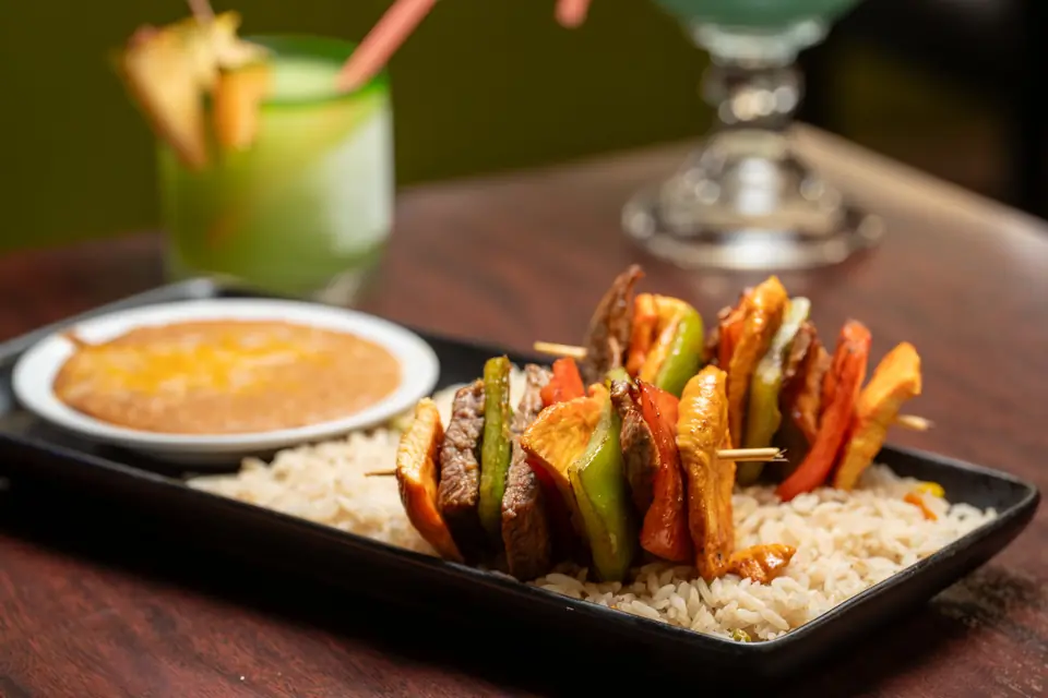 Shrimp and pepper skewers over rice